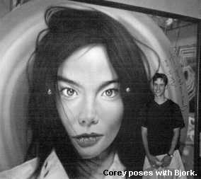 Corey poses with the giant picture of Bjork.